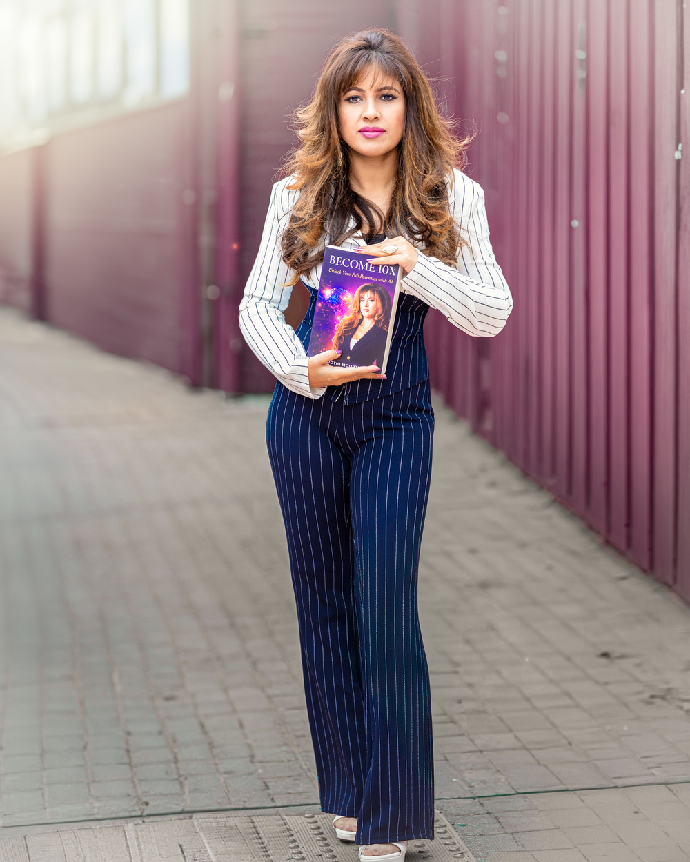Jothi Moorthy holding her book Become 10X