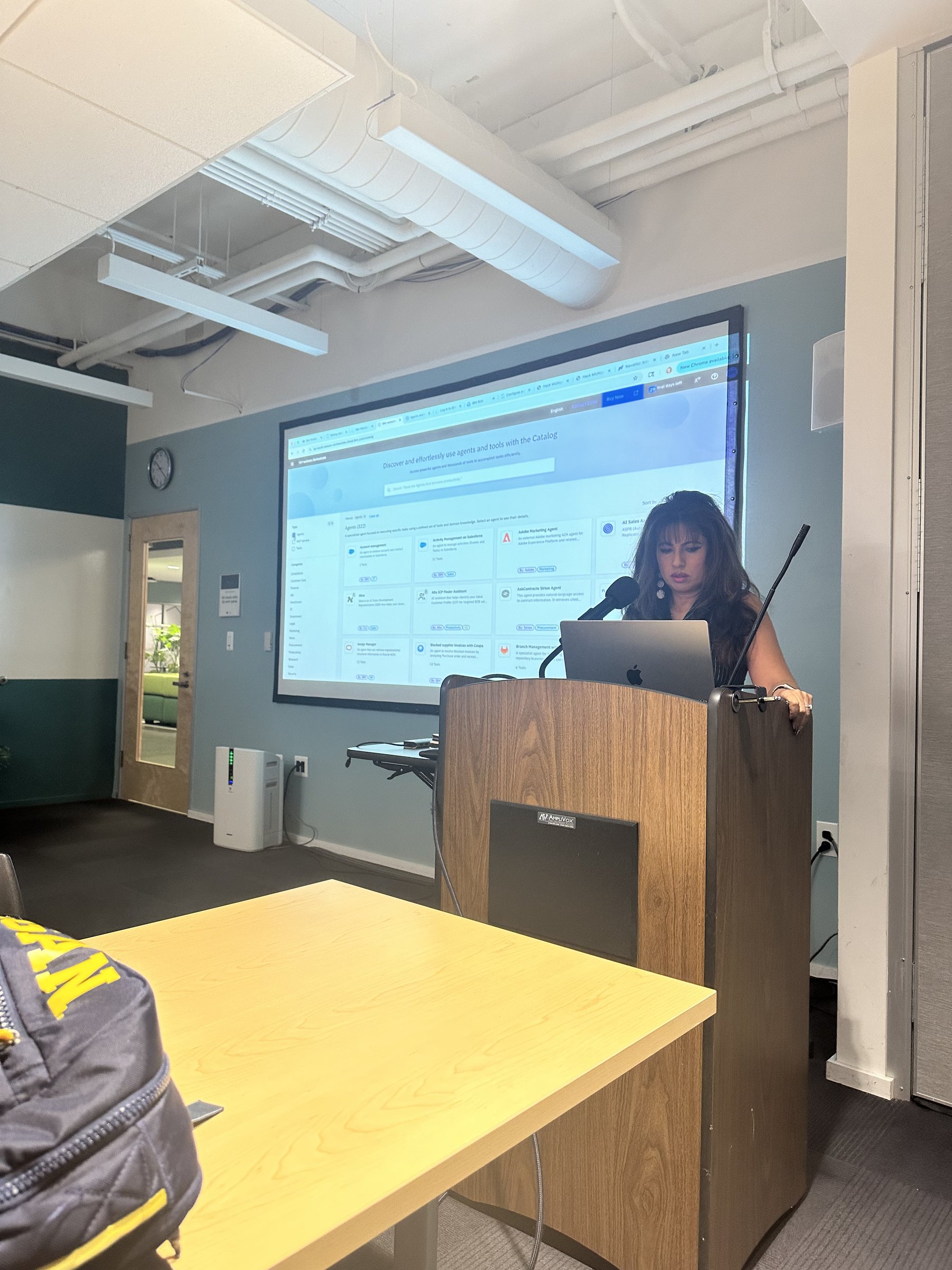Jothi Moorthy at the podium delivering the IBM Bob workshop at HackMichigan, TechTown Detroit