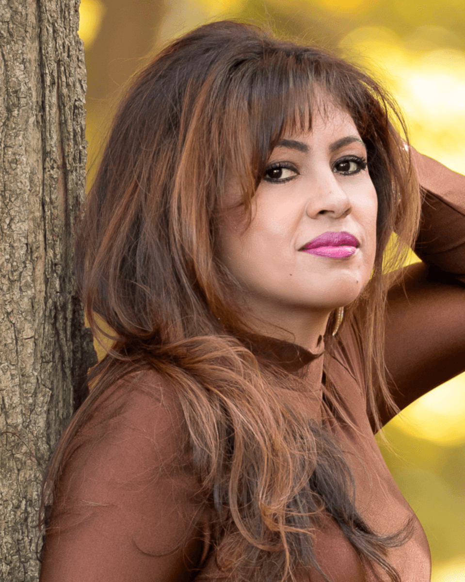 Jothi Moorthy portrait, brown outfit, warm tones